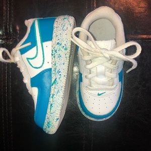 Blue customized baby Nike Air Force 1s.